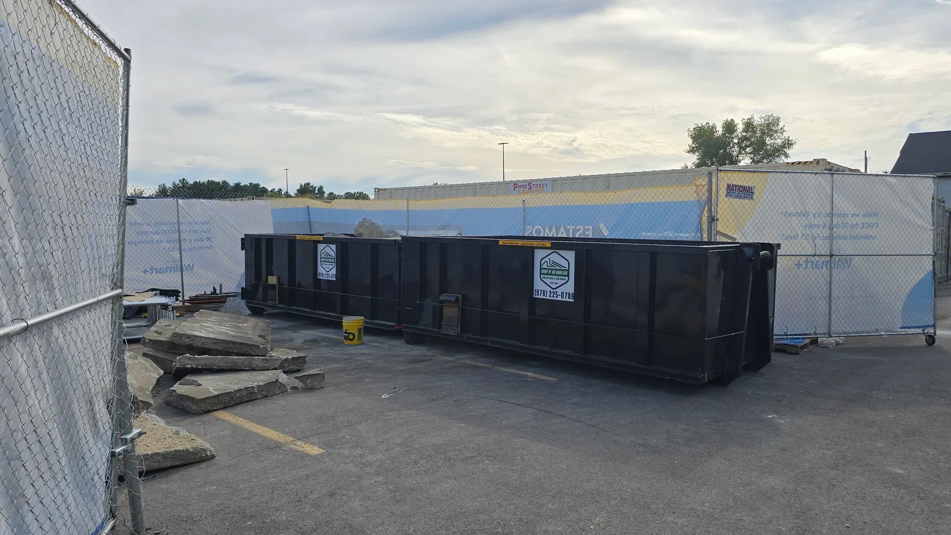 Pair of 20-yard roll-off dumpsters at a Walmart construction site